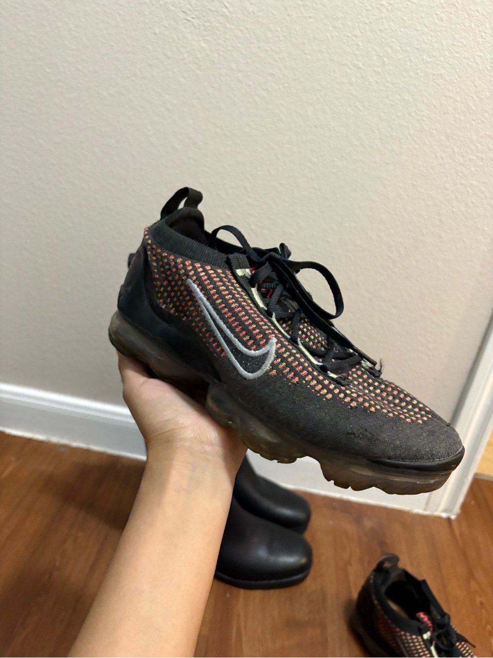 Nike Black Sneaker with Orange Accent Flyknit Upper